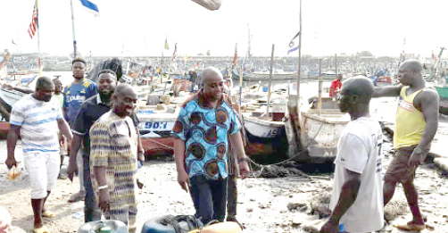 Yohane Armah Ashitey (3rd from right), MCE for Tema, interacting with some fishermen at Tema Manhean during a visit to the area